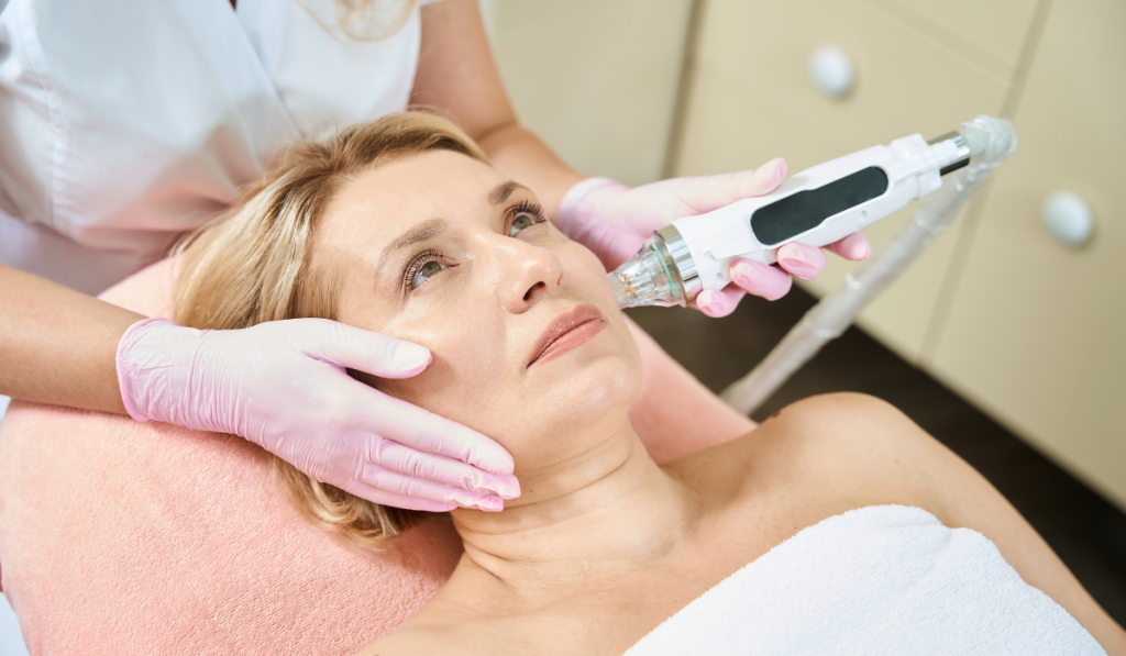 A fair-skinned woman receiving treatment on her face